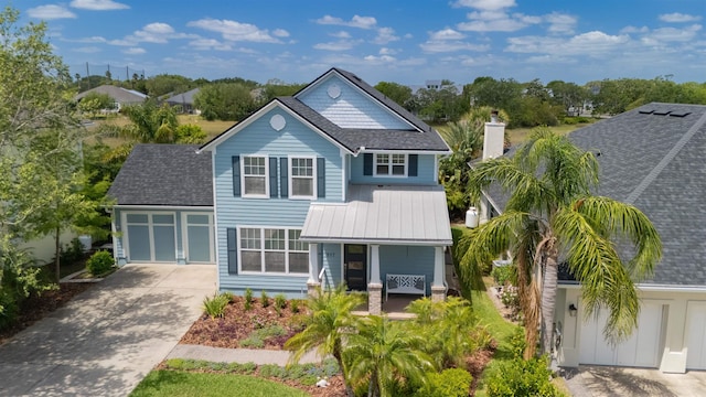 517 Weeping Willow Ln, Saint Augustine, FL 32080 - view of front of property featuring concrete driveway, covered porch, an attached garage, and roof with shingles