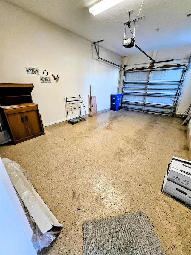 garage with baseboards and a garage door opener