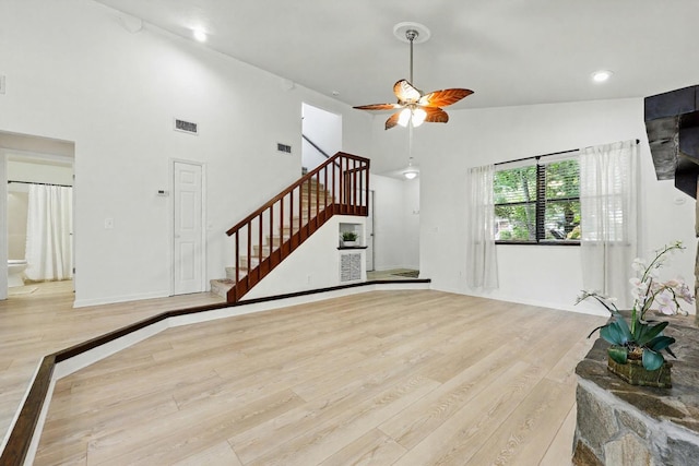 1684 Leon St, Saint Augustine, FL 32080 - unfurnished living room featuring wood finished floors, stairway, a high ceiling, a ceiling fan, and recessed lighting