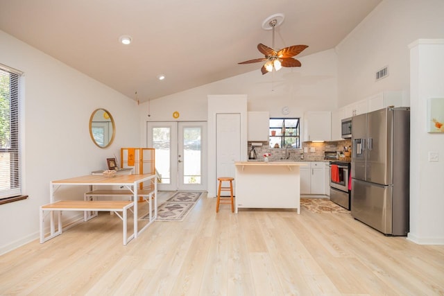 kitchen featuring stainless steel appliances, a peninsula, visible vents, light countertops, and french doors