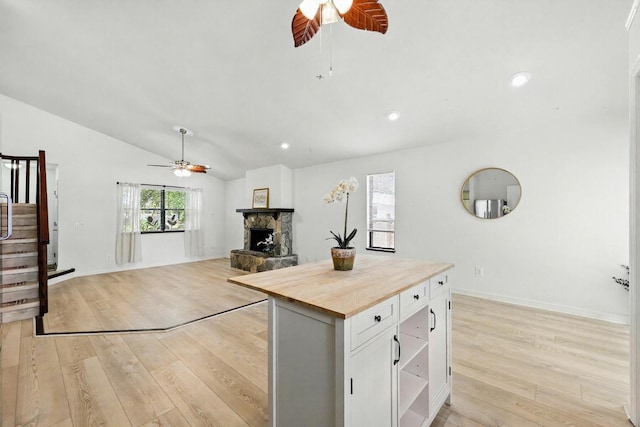 1684 Leon St, Saint Augustine, FL 32080 - kitchen with a ceiling fan, butcher block counters, a fireplace, light wood-style flooring, and vaulted ceiling