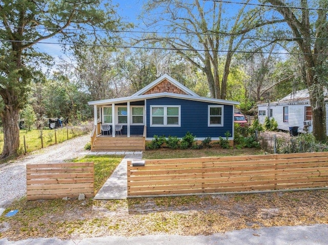 view of front facade featuring a fenced front yard and covered porch