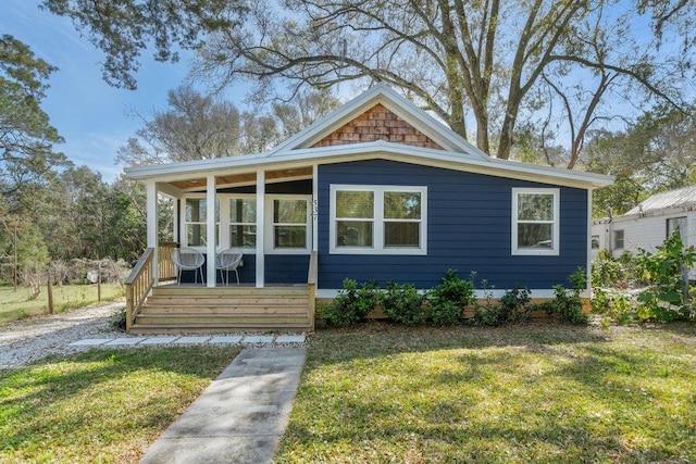 bungalow-style house featuring a front yard and covered porch