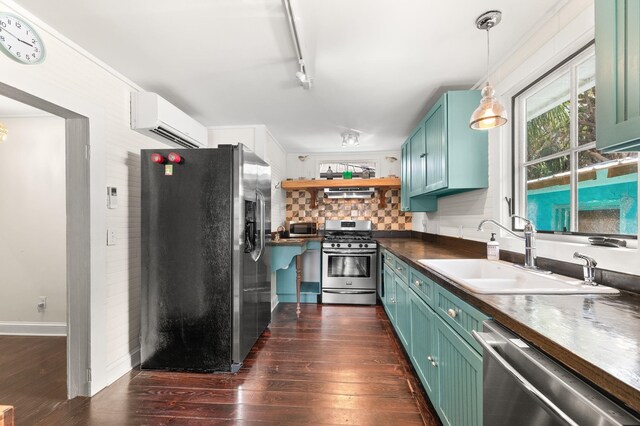 73 Kings Ferry Way, Saint Augustine, FL 32084 - kitchen with dark countertops, dark wood finished floors, appliances with stainless steel finishes, a wall mounted AC, and a sink