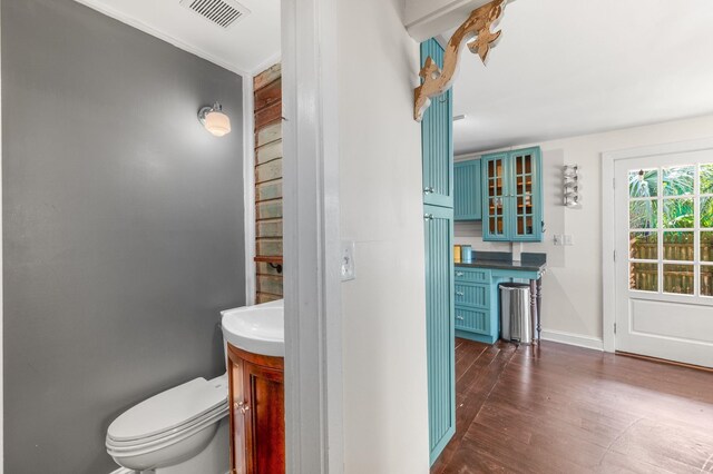 73 Kings Ferry Way, Saint Augustine, FL 32084 - half bathroom featuring visible vents, toilet, wood finished floors, baseboards, and vanity