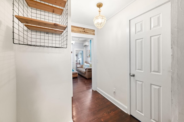 73 Kings Ferry Way, Saint Augustine, FL 32084 - corridor with wood finished floors, baseboards, ornamental molding, an AC wall unit, and a notable chandelier