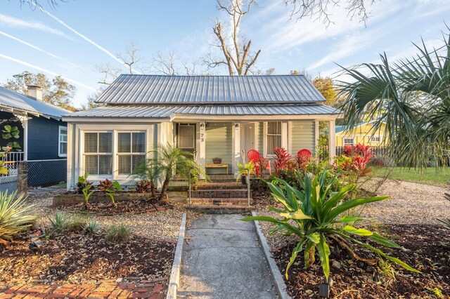 73 Kings Ferry Way, Saint Augustine, FL 32084 - bungalow-style house with fence, covered porch, and metal roof