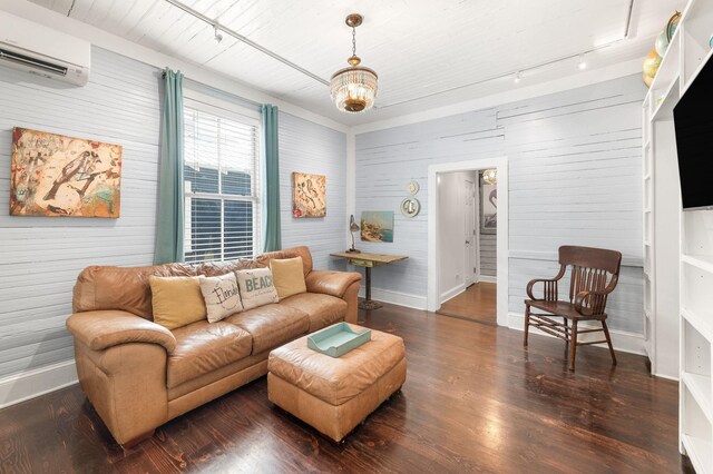 73 Kings Ferry Way, Saint Augustine, FL 32084 - living area featuring baseboards, an AC wall unit, rail lighting, wood finished floors, and a notable chandelier