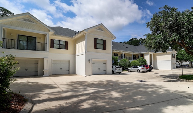 view of front of house with a garage, stucco siding, and concrete driveway