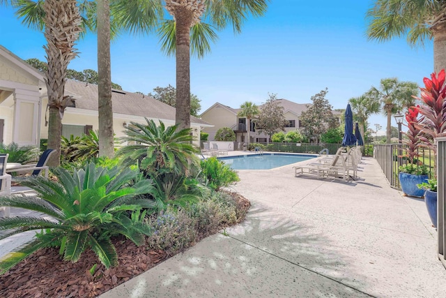 community pool featuring a patio area and fence