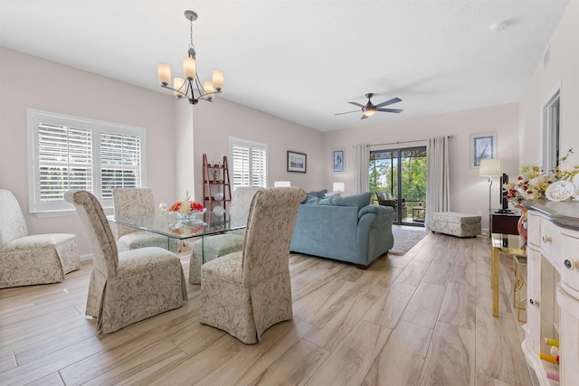 113 Laurel Wood Way Unit 101, Saint Augustine, FL 32086 - dining area with light wood-style floors, ceiling fan with notable chandelier, and visible vents