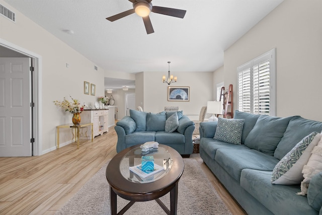 113 Laurel Wood Way Unit 101, Saint Augustine, FL 32086 - living area featuring baseboards, visible vents, light wood finished floors, and ceiling fan with notable chandelier
