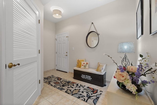 interior space with baseboards and light tile patterned floors