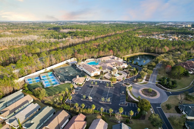 birds eye view of property featuring a forest view