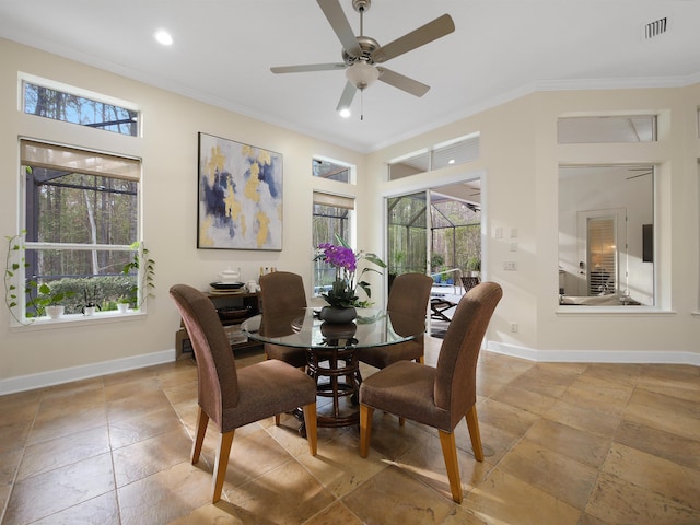 dining area featuring ceiling fan, a high ceiling, visible vents, baseboards, and ornamental molding