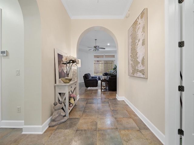 corridor featuring baseboards, arched walkways, and ornamental molding