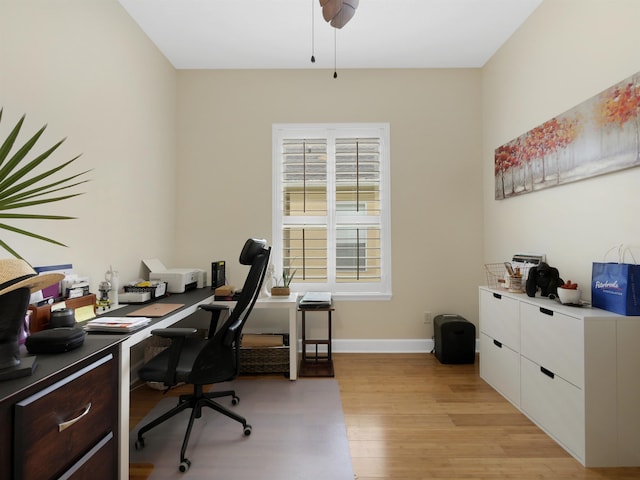 office area featuring light wood-style floors and baseboards