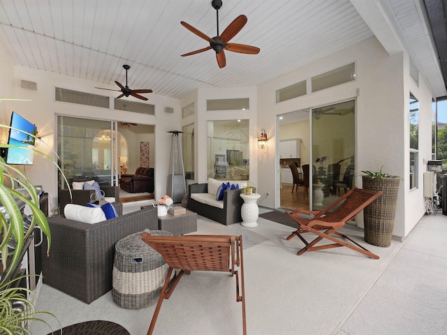 view of patio with an outdoor living space and a ceiling fan