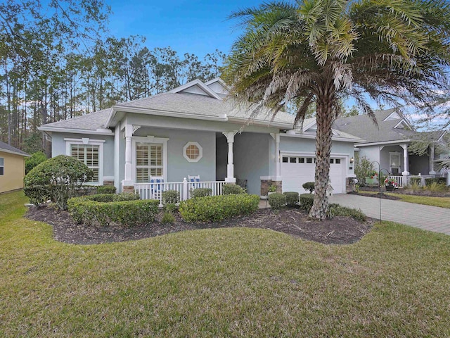 view of front of property with a porch, decorative driveway, an attached garage, and stucco siding