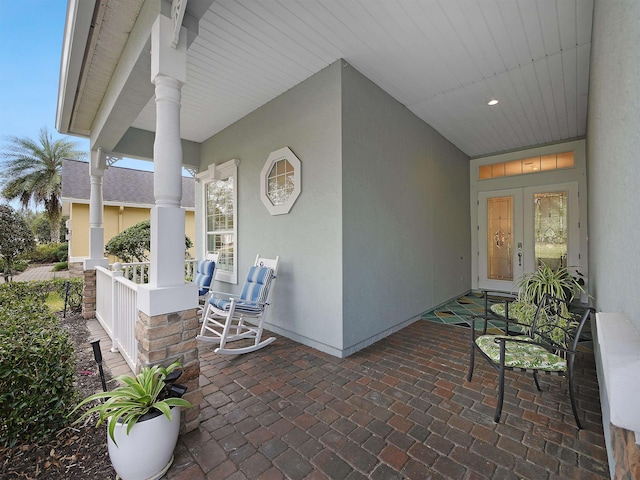 view of patio featuring covered porch and french doors