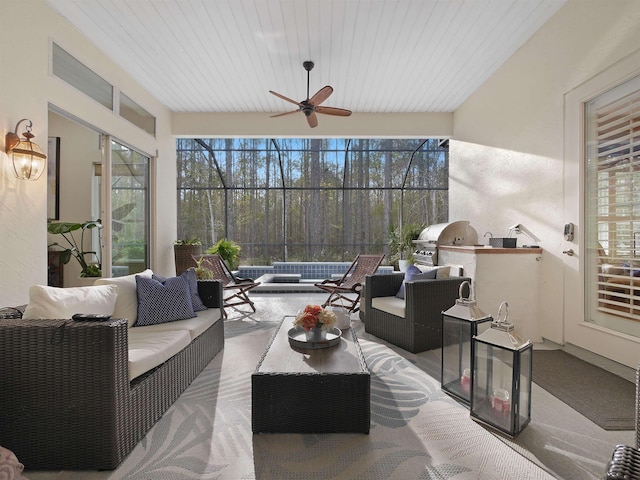 sunroom with ceiling fan and wood ceiling