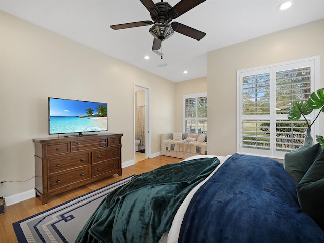 bedroom featuring light wood-style floors, baseboards, connected bathroom, and recessed lighting