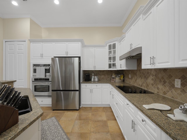 kitchen with appliances with stainless steel finishes, white cabinetry, glass insert cabinets, and under cabinet range hood