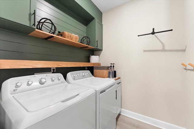 839 Lightsey Crossing Ln, Saint Augustine, FL 32084 - washroom with washer and clothes dryer, cabinet space, and light wood-style floors