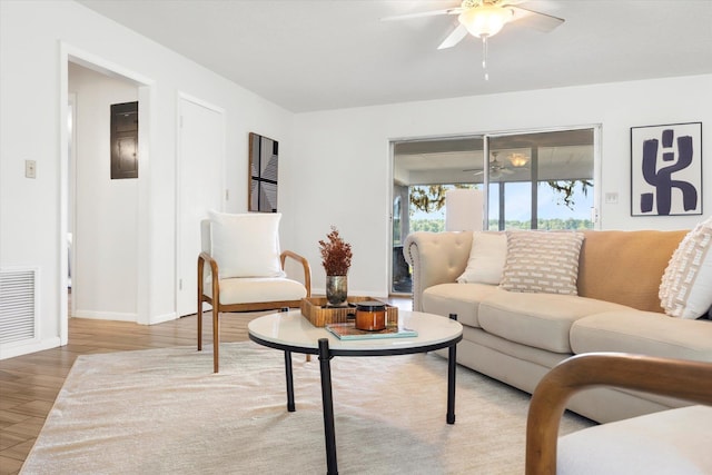 living room with light hardwood / wood-style floors and ceiling fan