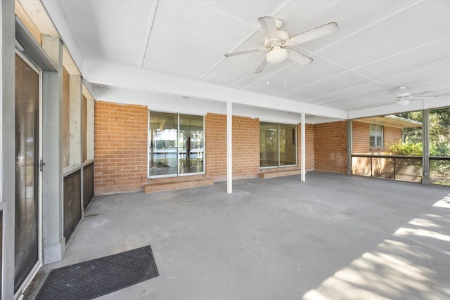 unfurnished sunroom with ceiling fan and plenty of natural light