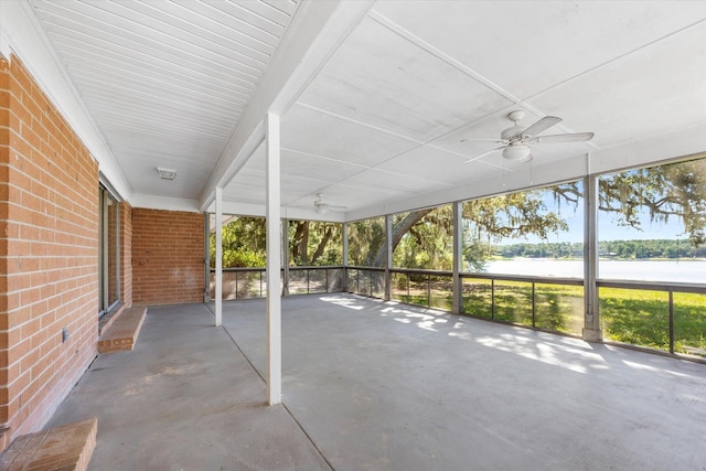 unfurnished sunroom featuring a healthy amount of sunlight and a water view