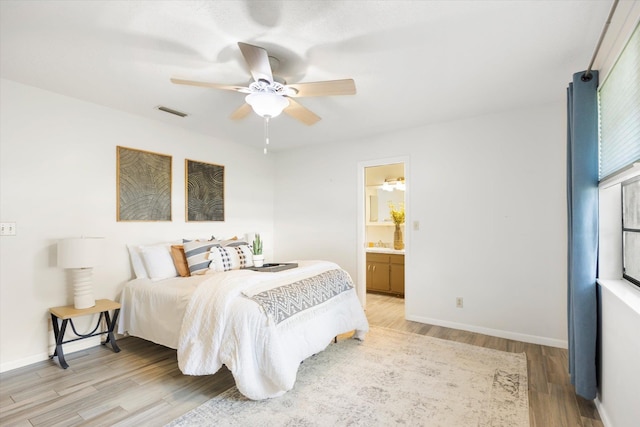 bedroom featuring connected bathroom, ceiling fan, and wood-type flooring