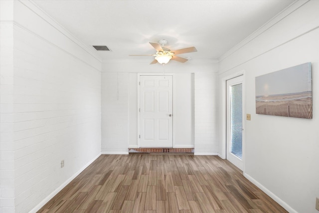 unfurnished room featuring ceiling fan, crown molding, and dark wood-type flooring