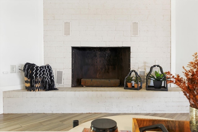 room details featuring a fireplace and hardwood / wood-style floors