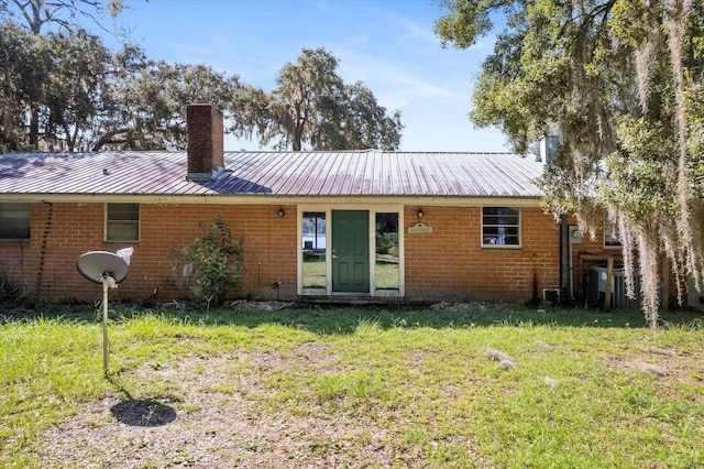 rear view of house with a lawn