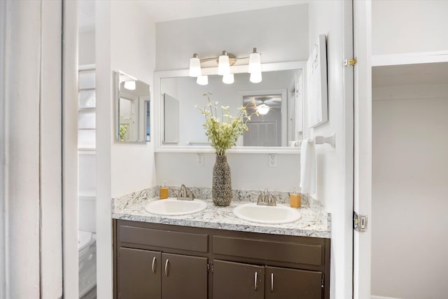 bathroom featuring vanity and toilet