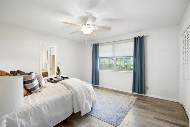 bedroom with a closet, hardwood / wood-style flooring, ensuite bath, and ceiling fan