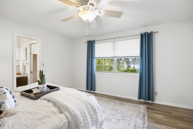 bedroom with wood-type flooring, ensuite bathroom, and ceiling fan