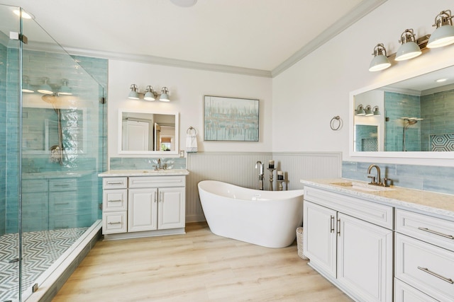 104 Fiddler Crab Ln, Saint Augustine, FL 32080 - full bath with a stall shower, ornamental molding, two vanities, wood finished floors, and a wainscoted wall