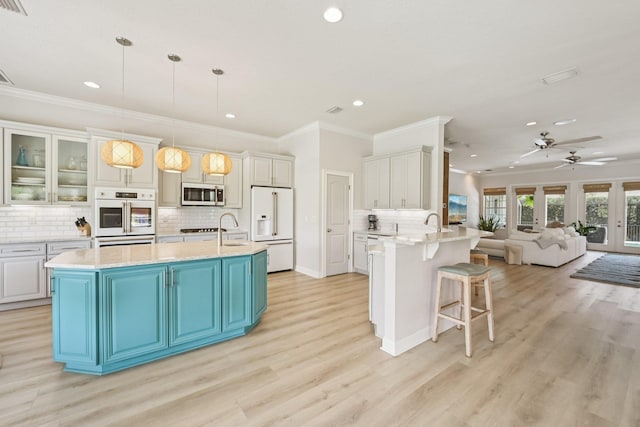 104 Fiddler Crab Ln, Saint Augustine, FL 32080 - kitchen with white appliances, recessed lighting, crown molding, open floor plan, and a kitchen breakfast bar