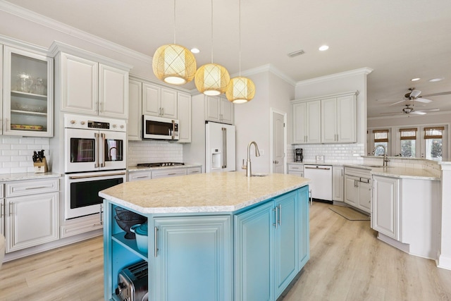 104 Fiddler Crab Ln, Saint Augustine, FL 32080 - kitchen featuring white appliances, blue cabinetry, tasteful backsplash, light wood-style floors, and recessed lighting