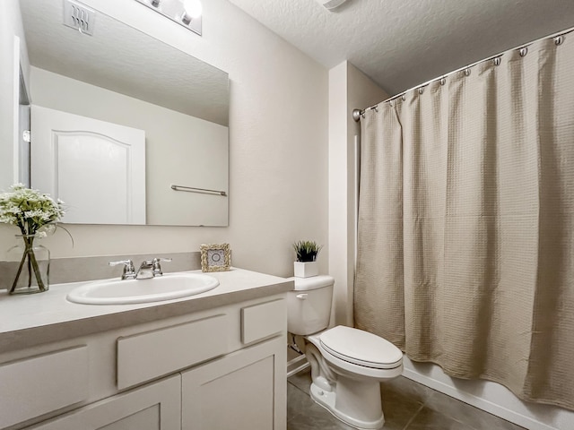 full bathroom featuring shower / bath combination with curtain, a textured ceiling, vanity, tile patterned flooring, and toilet