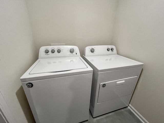 clothes washing area featuring washer and clothes dryer