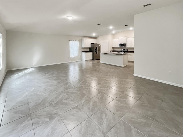 unfurnished living room featuring lofted ceiling