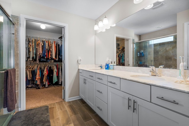 bathroom with vanity, an enclosed shower, and wood-type flooring