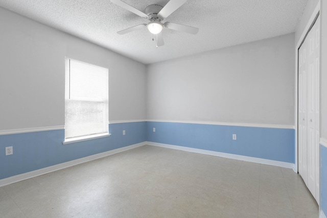 spare room with light floors, a textured ceiling, baseboards, and ceiling fan