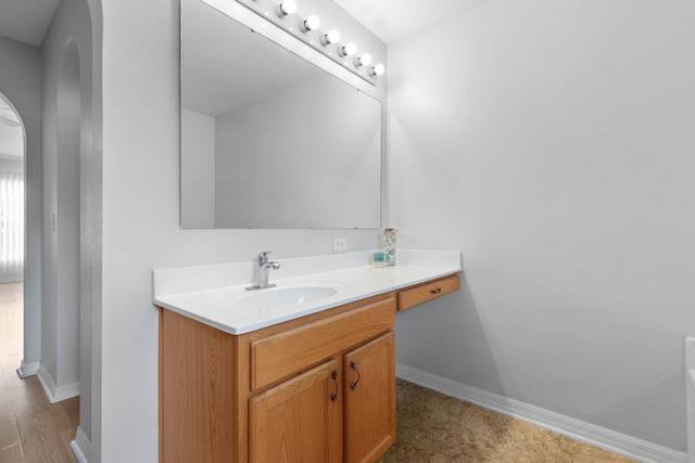 bathroom with baseboards and vanity