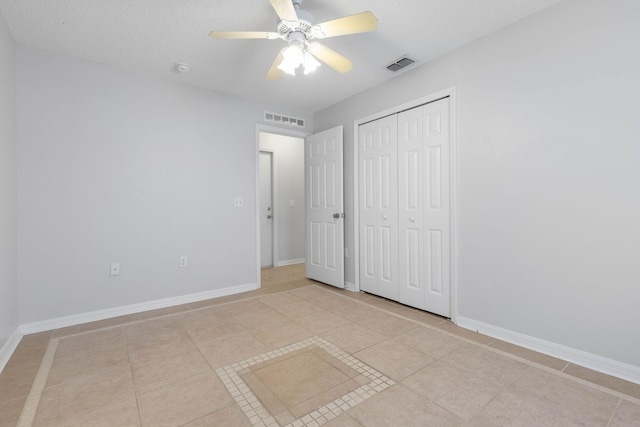 unfurnished bedroom featuring baseboards, visible vents, a closet, and ceiling fan