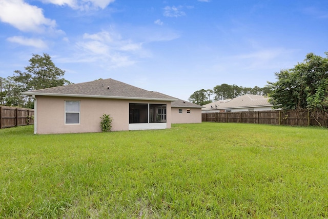 back of house with a yard, a fenced backyard, roof with shingles, and stucco siding