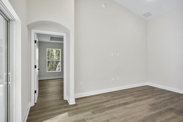 empty room with dark hardwood / wood-style flooring